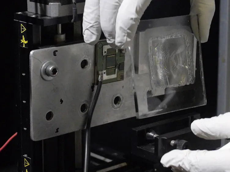 Indoor Experimental Assessment of the Efficiency and Irradiance Spot of the Achromatic Doublet on Glass (ADG) Fresnel Lens for Concentrating Photovoltaics