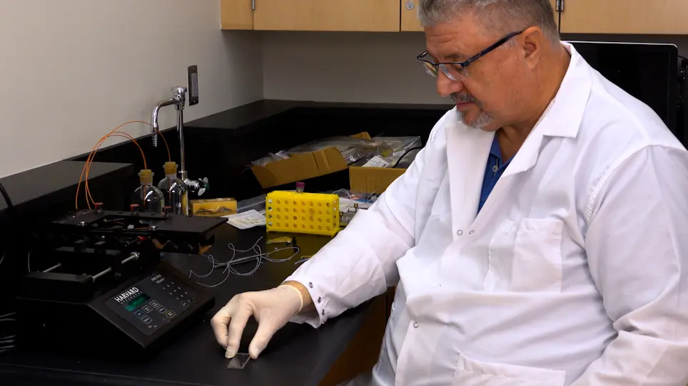 Use of Dual Optical Tweezers and Microfluidics for Single-Molecule Studies